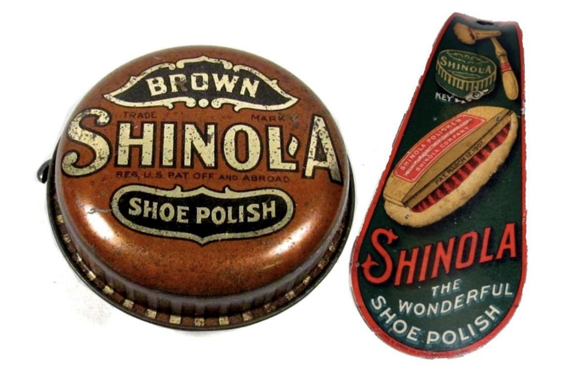 Two vintage Shinola shoe polish containers—one round tin labeled 'Brown Shoe Polish' and one brush-style tin with red and green branding.